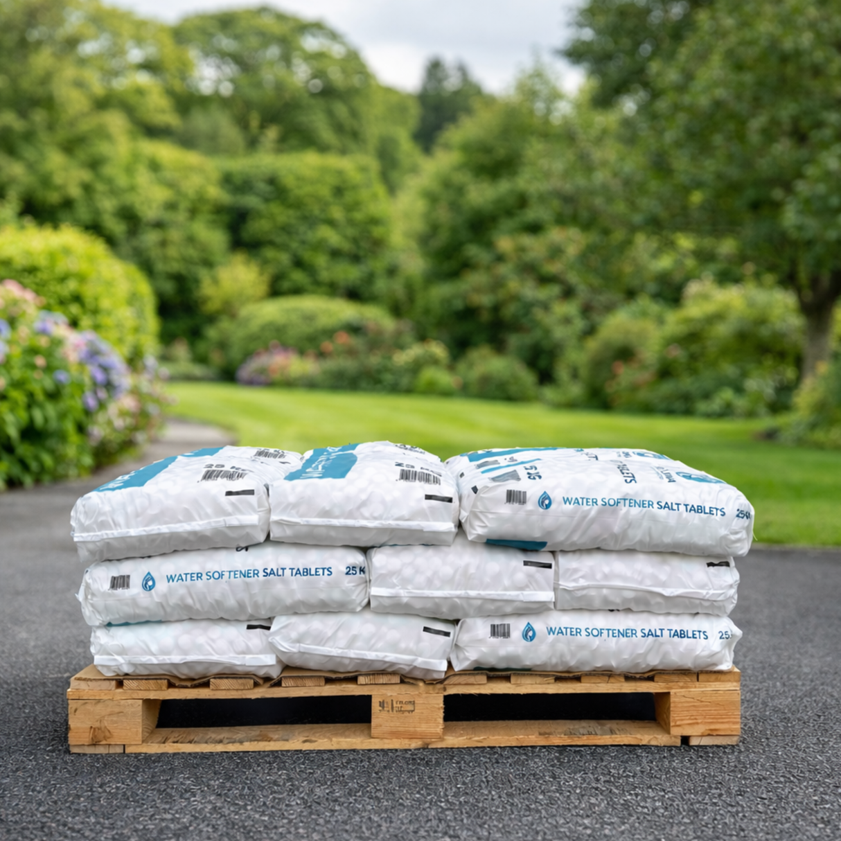 Stack of water softener salt tablets on a wooden pallet with a garden background