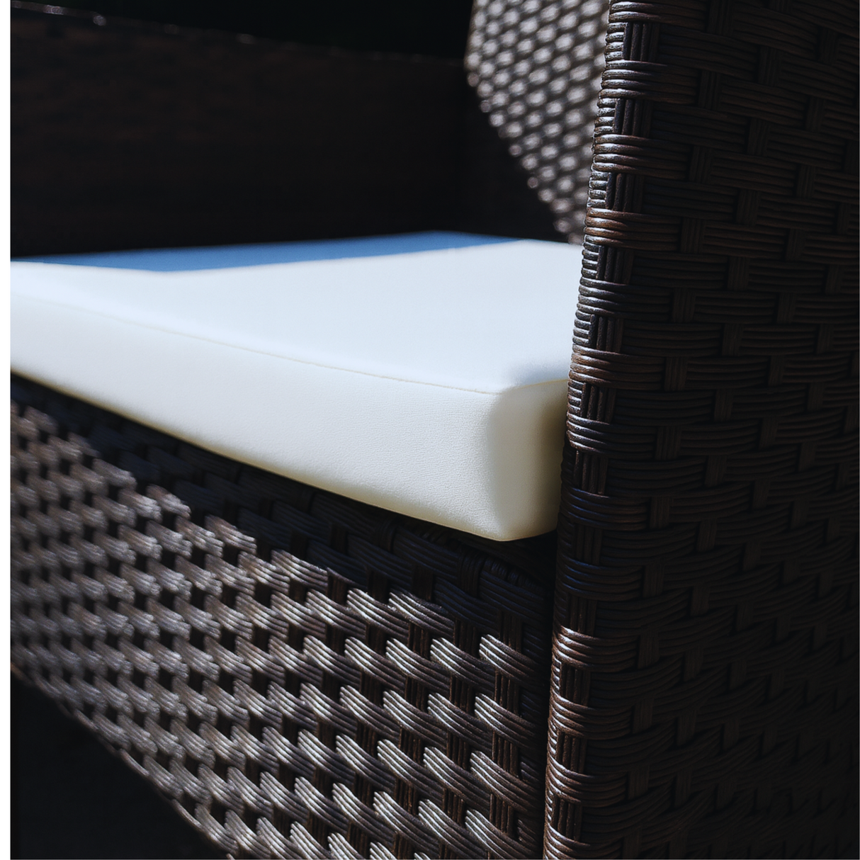 Close-up of a wicker chair with a white cushion