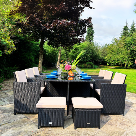 Outdoor patio set with table and chairs in a garden setting