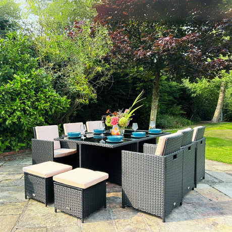 Outdoor patio set with table and chairs in a garden setting
