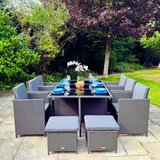 Outdoor patio set with table and chairs in a garden setting
