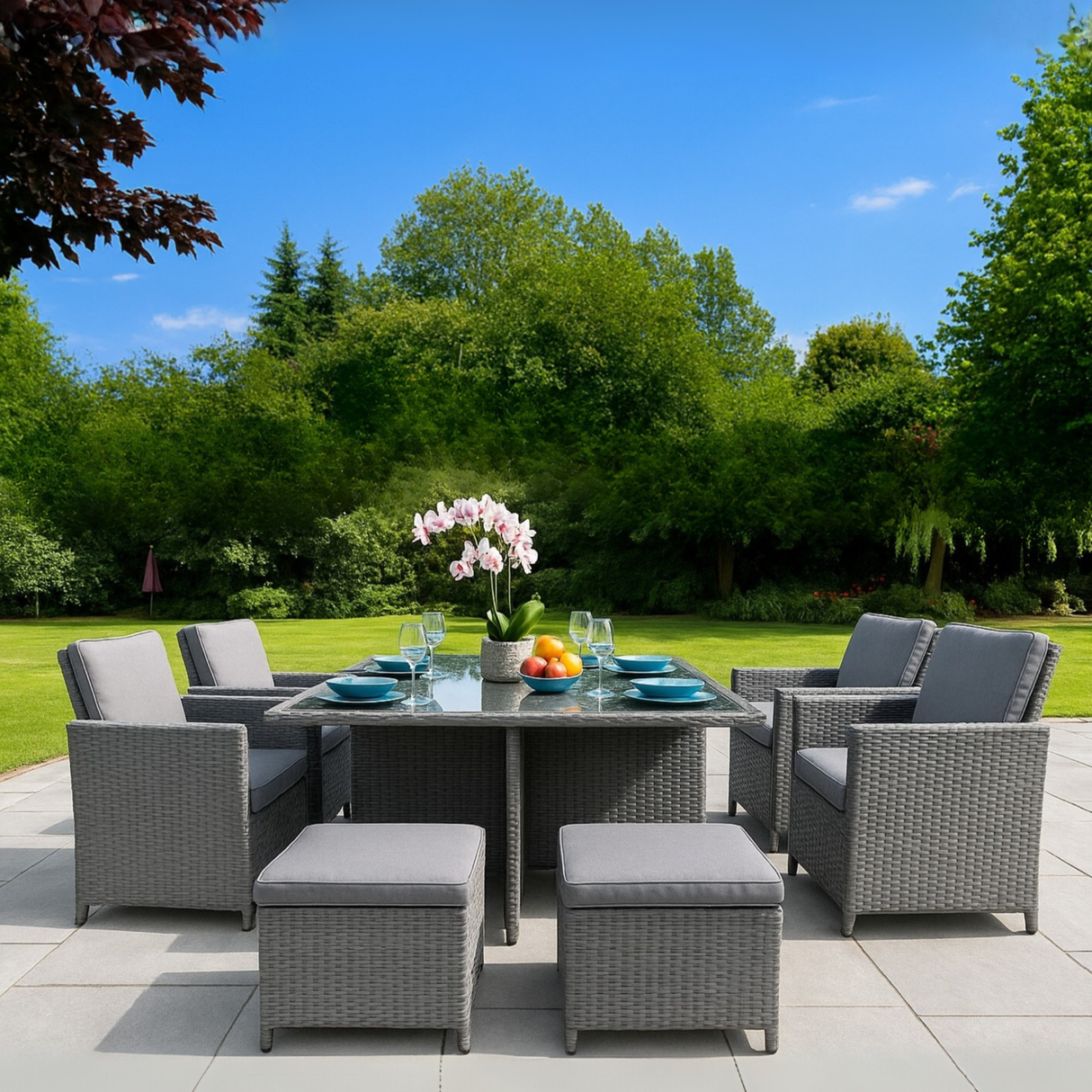Outdoor patio set with table and chairs in a garden setting