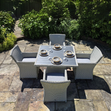 Outdoor patio set with table and chairs on a stone patio