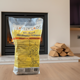 Bag of Lävely Lags kiln-dried hardwood firewood in front of a fireplace.