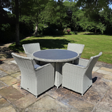 Outdoor patio set with round table and four chairs.